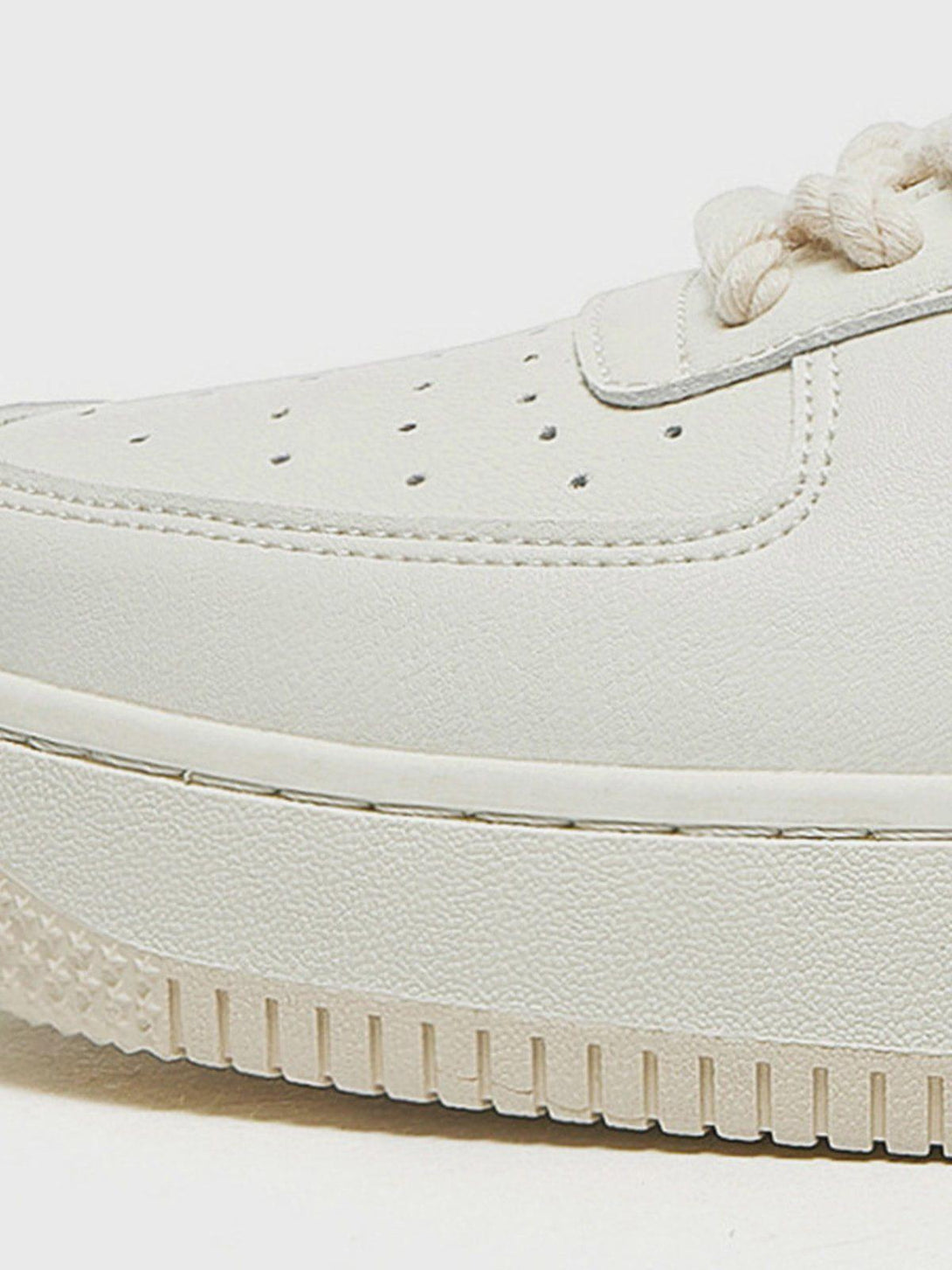 Close-up of TALISHKO casual shoes highlighting textured sole and detailed stitching.