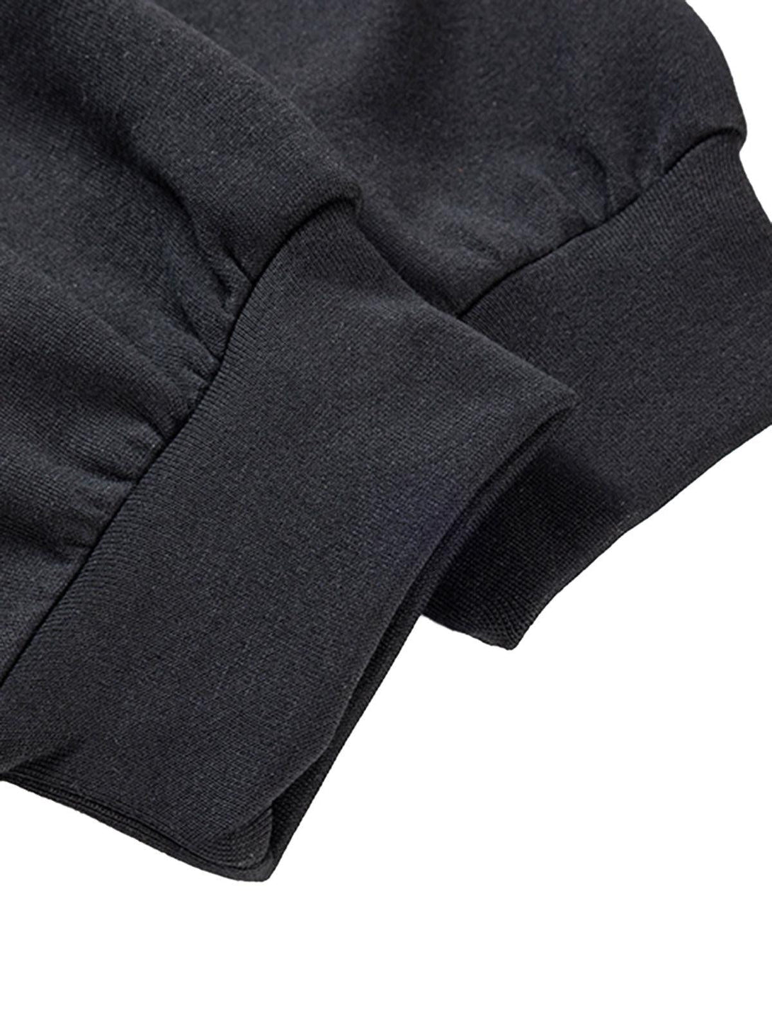 Focusing on the cuff details of the TALISHKO cross graphic hoodie, highlighting its texture.