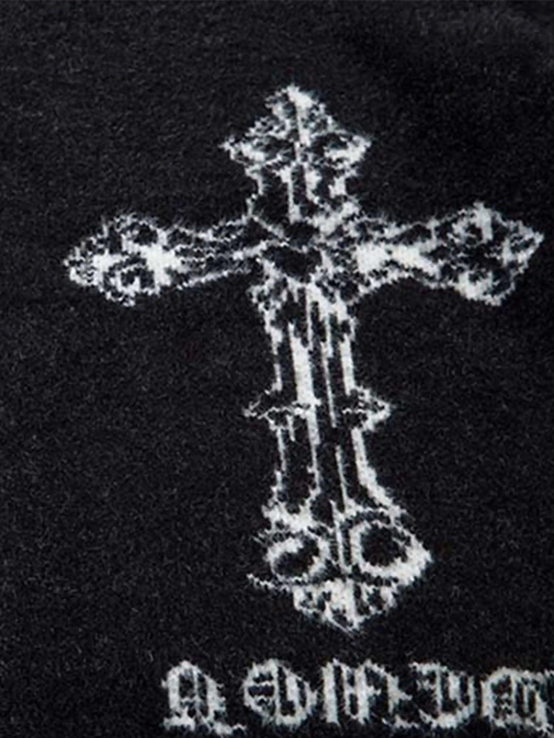 A detailed view of the jacquard cross design on a TALISHKO cardigan.
