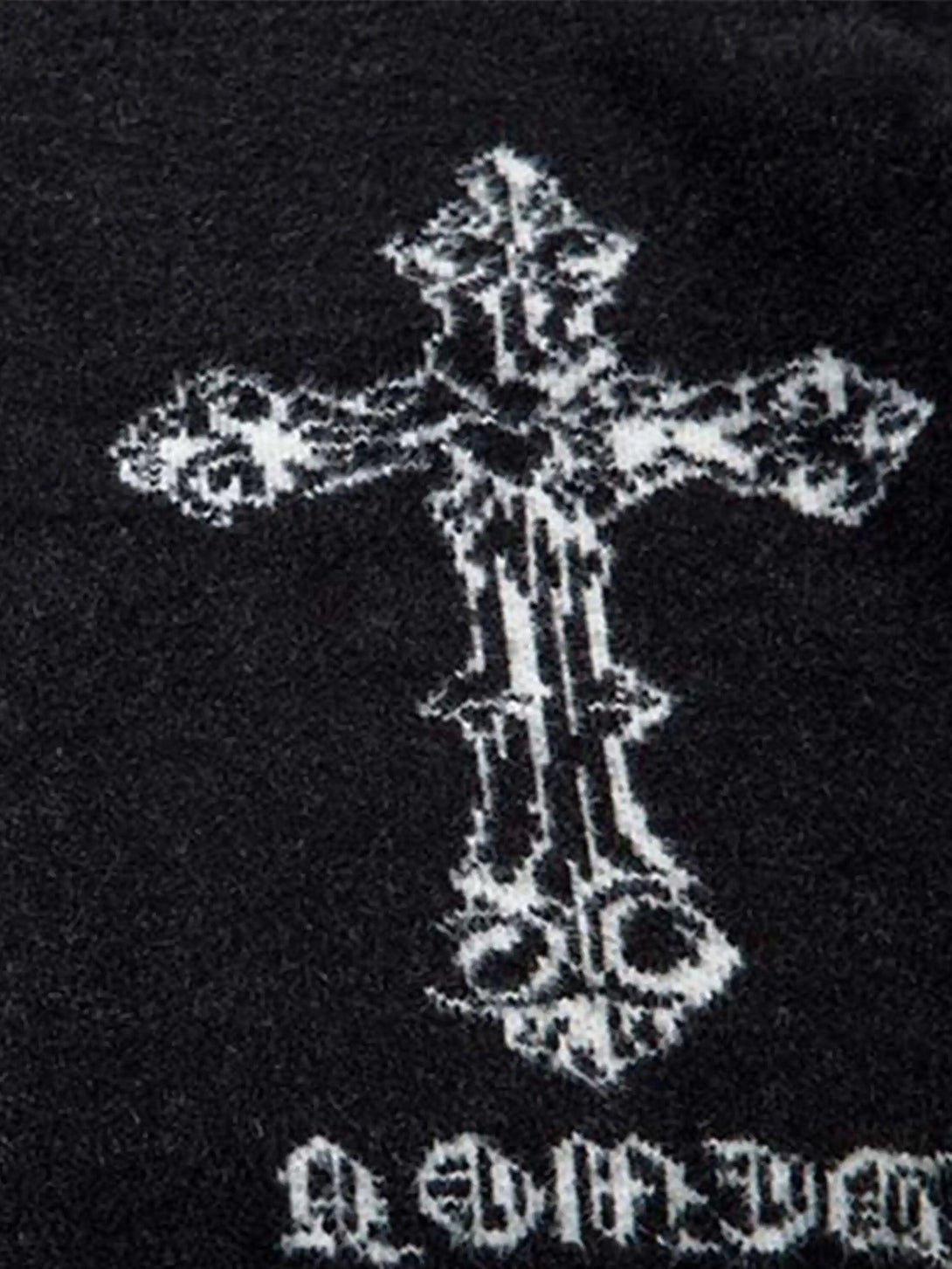 Intricate look at the jacquard cross pattern on a TALISHKO cardigan, highlighting gothic style.