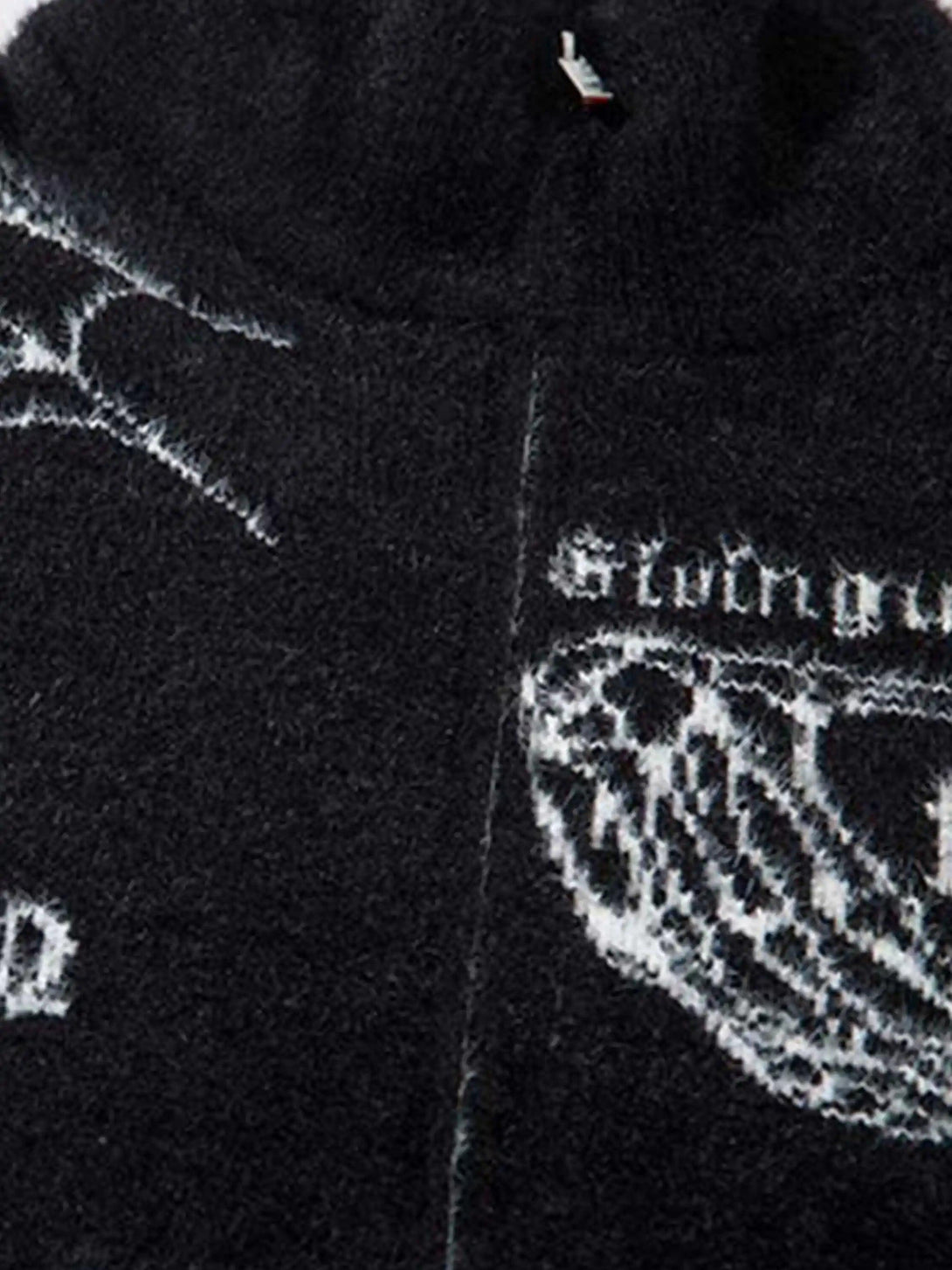Intricate look at the jacquard texture and design details on a TALISHKO cardigan.