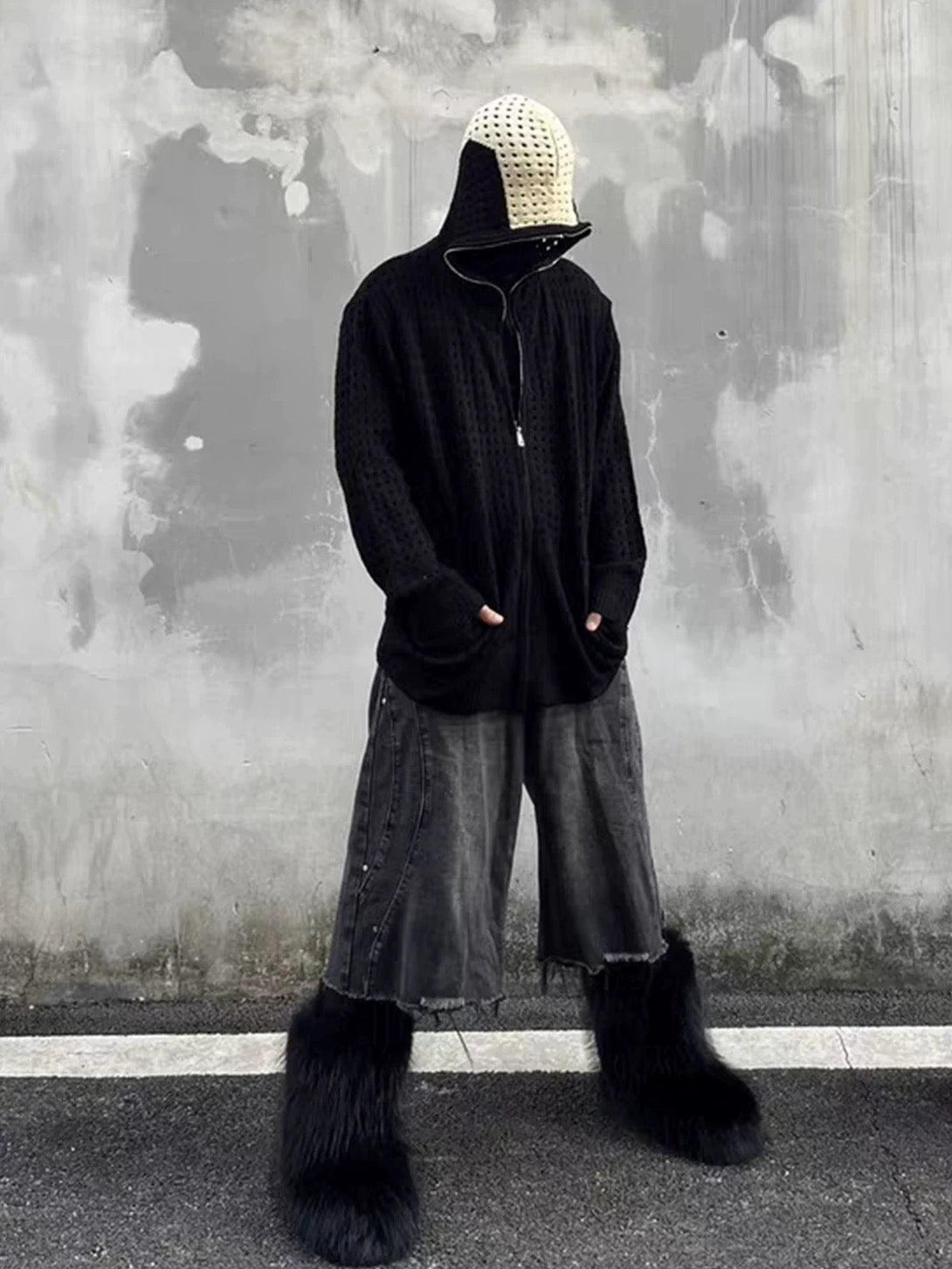 Model in a TALISHKO hooded jacket with cross jacquard, styled with edgy denim shorts and furry boots.