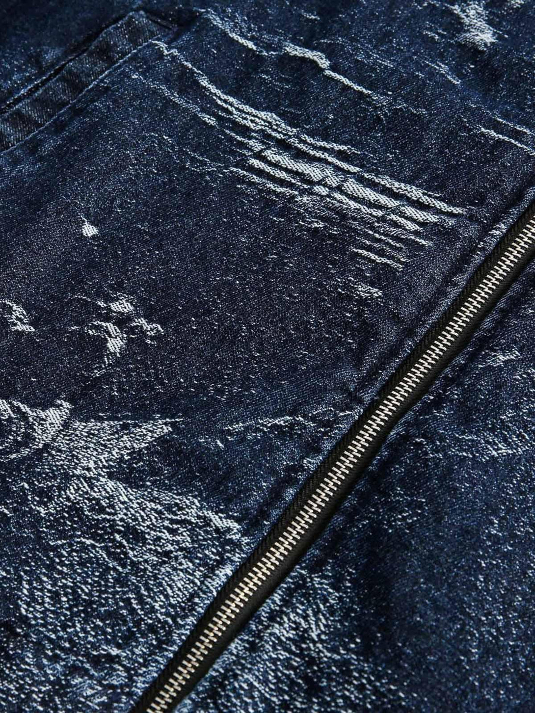 Texture and pattern showcased on a TALISHKO denim jacket with a prominent zipper detail.