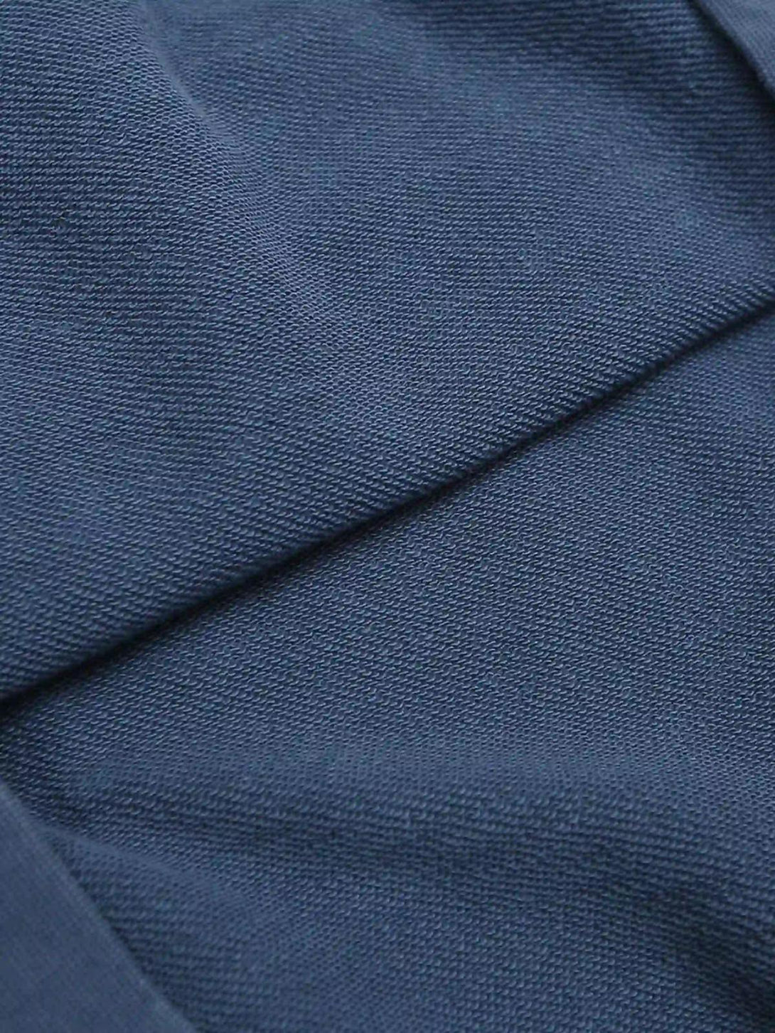 Zoomed-in texture of blue washed hoodie fabric by TALISHKO, highlighting its fine detail.