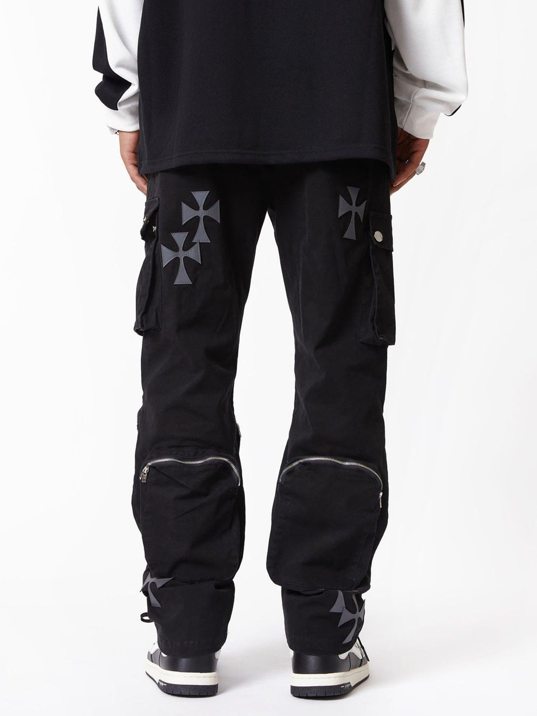 Back view of TALISHKO's cross-printed multi-pocket casual pants, highlighting zipper details.