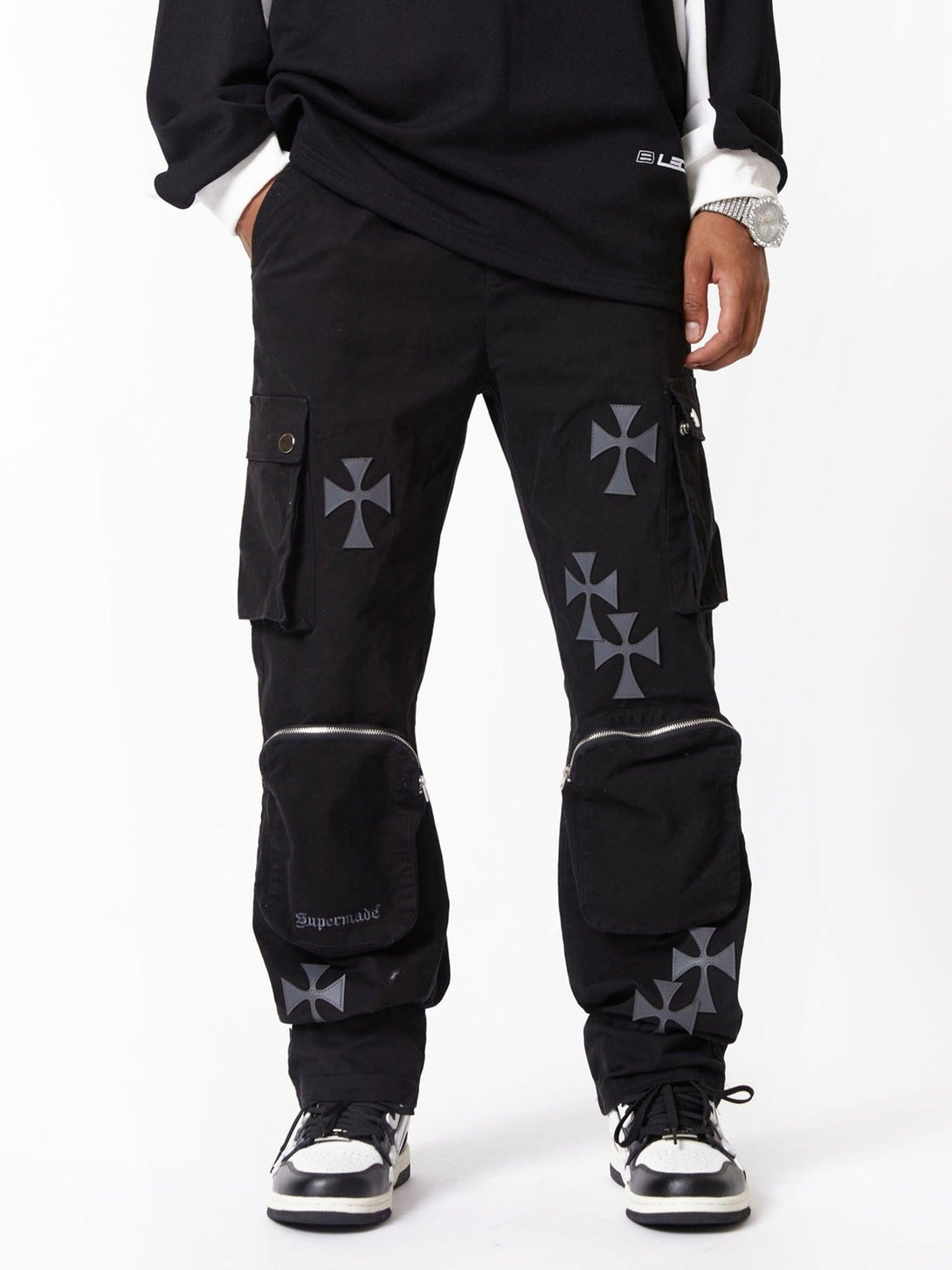 Black cargo pants with cross prints and multiple pockets, styled by TALISHKO.