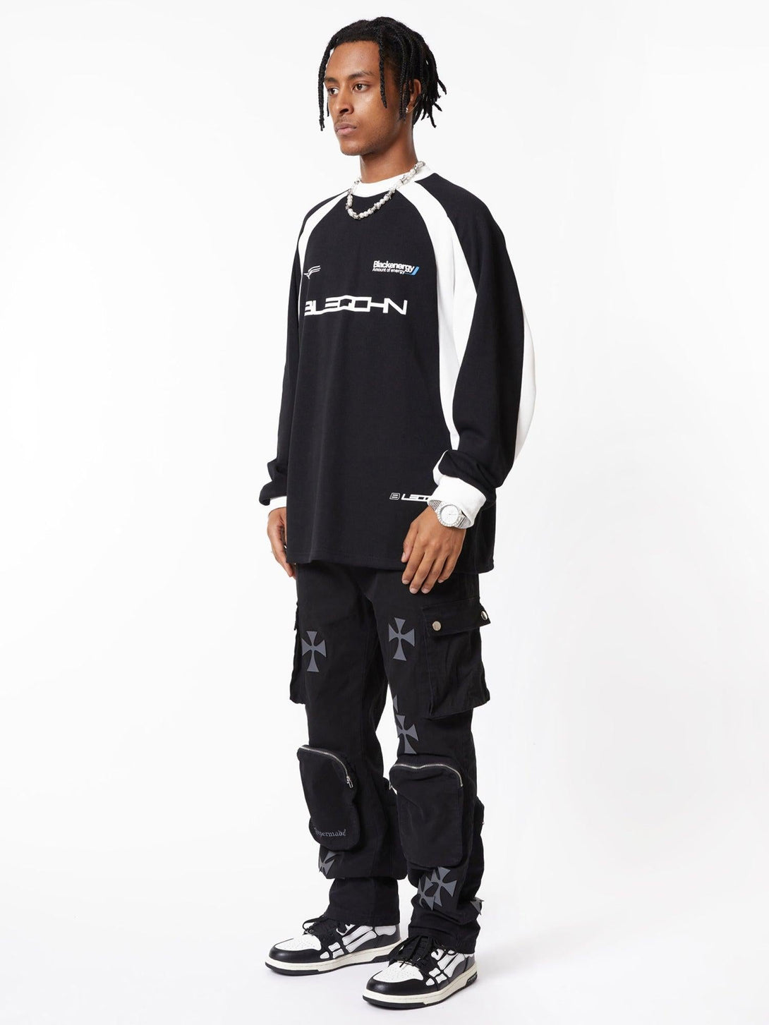 Model wearing TALISHKO cross-printed casual pants with multiple pockets for a trendy streetwear look.