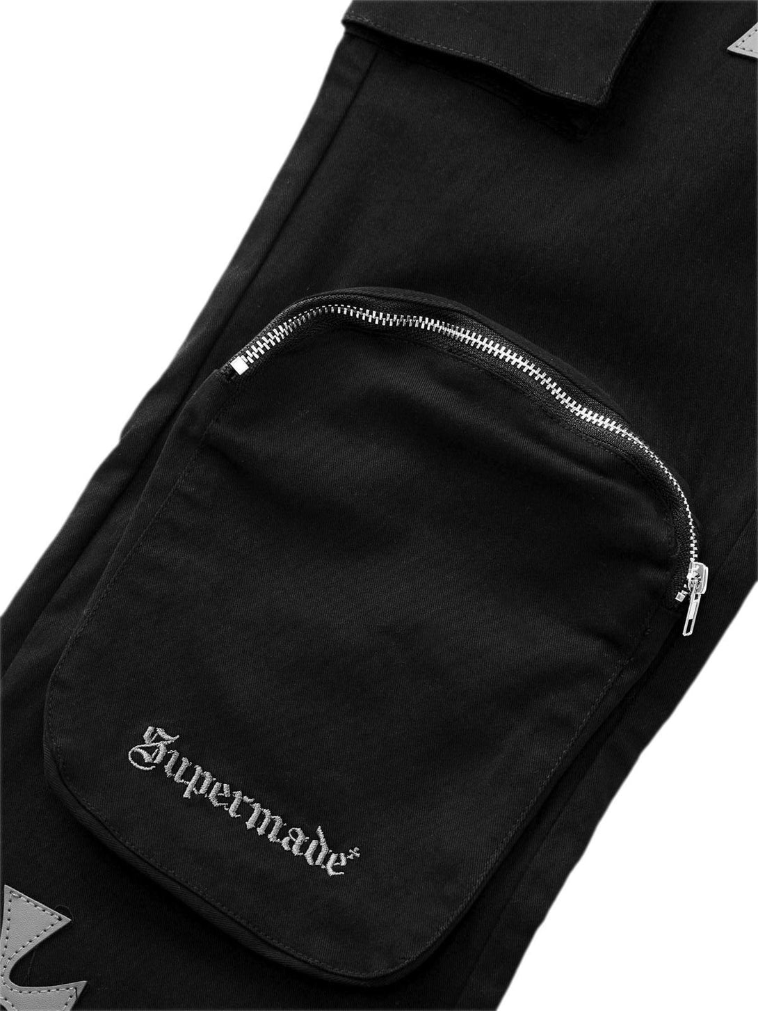 A detailed view of TALISHKO's cross-printed pocket design on casual pants, highlighting urban flair.