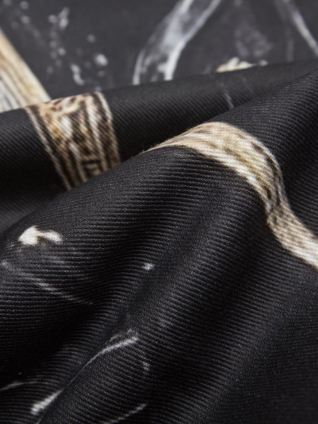 Zoomed-in texture of TALISHKO bomber jacket, showcasing the intricate cross print design.