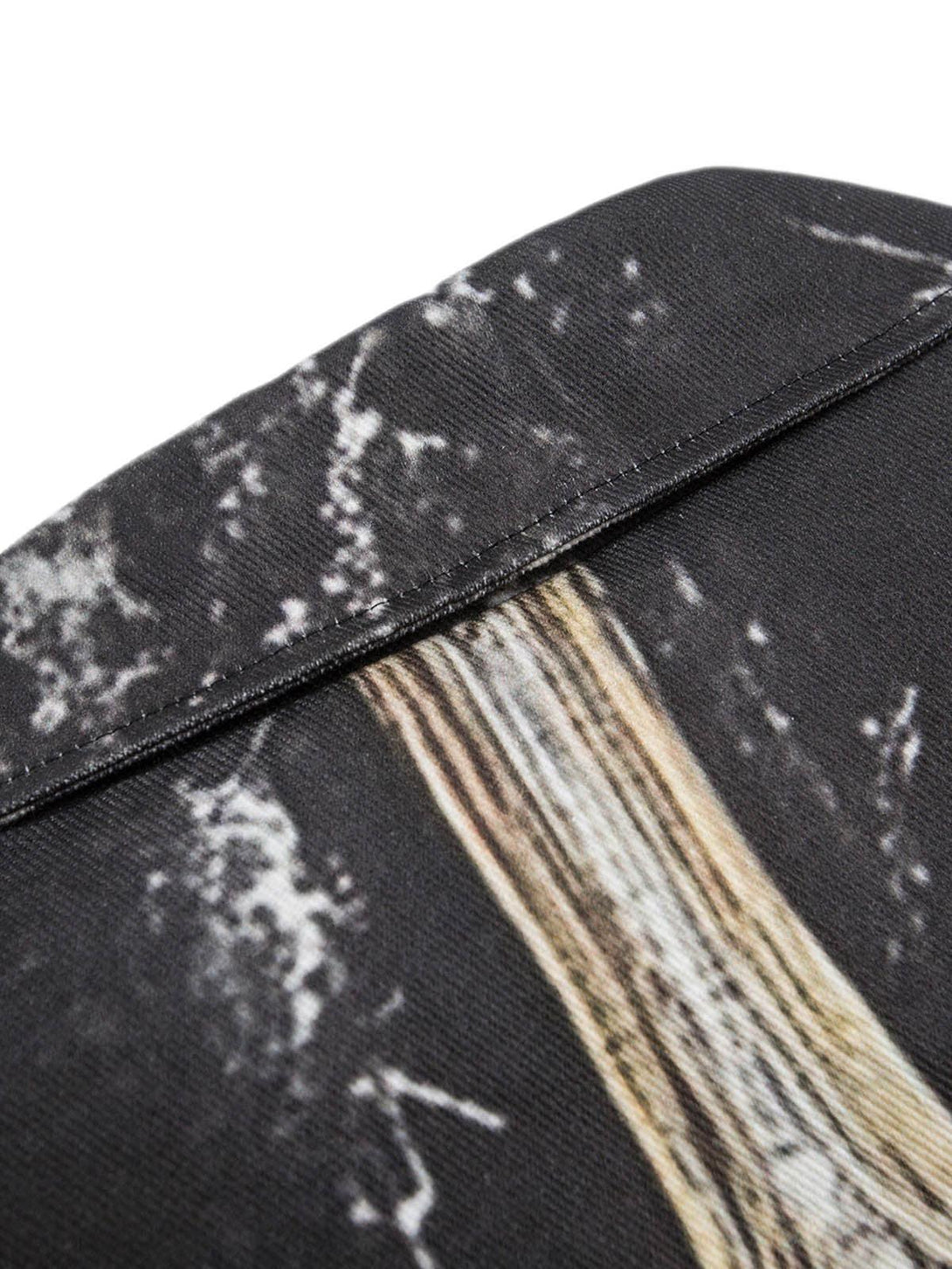 Intricate look at TALISHKO's quilted bomber jacket, highlighting the cross print texture.