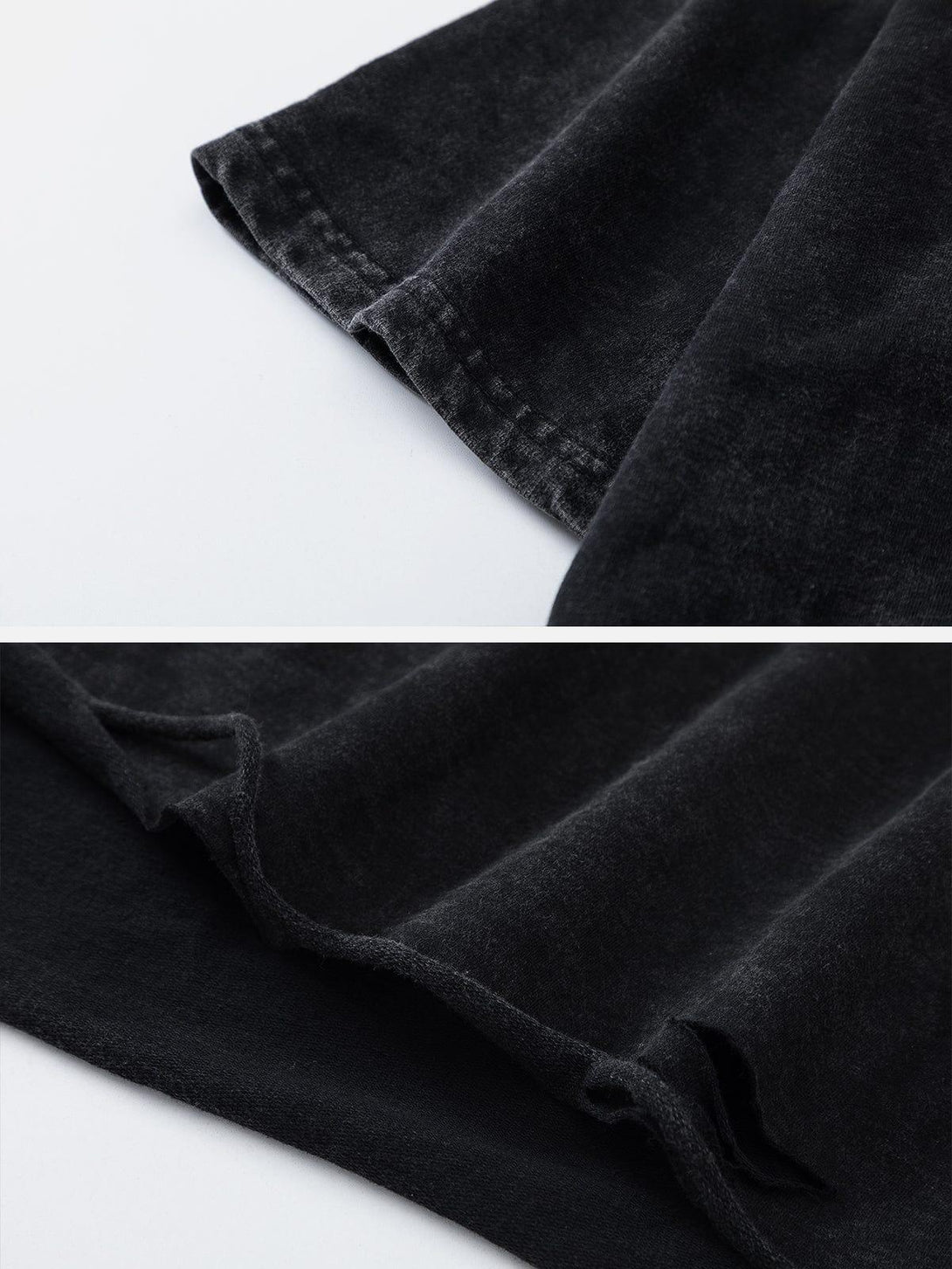 Detailed fabric and stitching of a washed black tee by TALISHKO, highlighting texture.