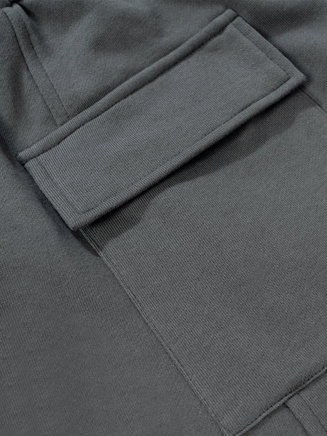 Zoomed-in view of TALISHKO's cut distressed shorts showcasing the pocket detail and texture.
