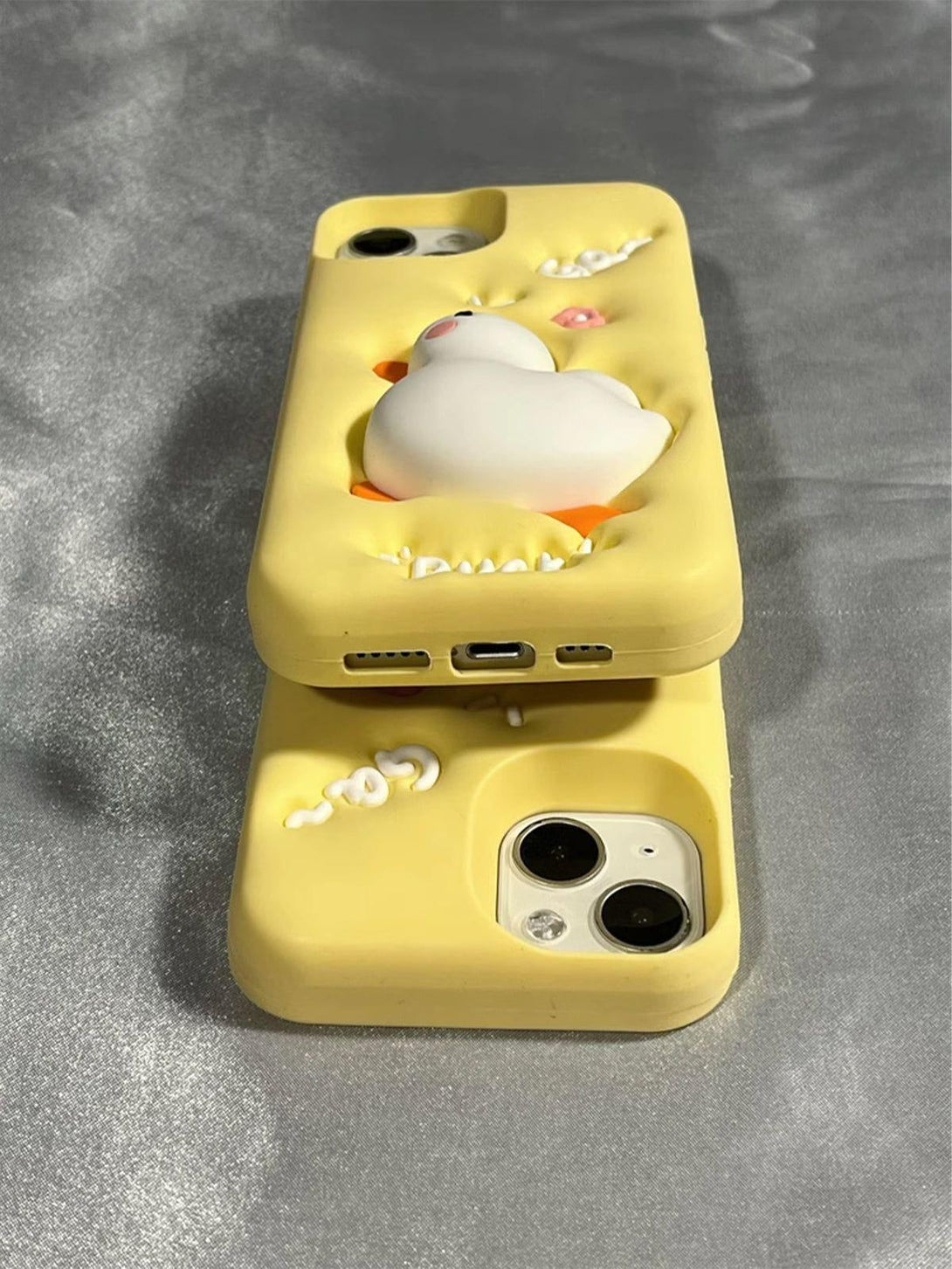 Playful 3D duck phone case by TALISHKO, showcasing a yellow design with whimsical accents.