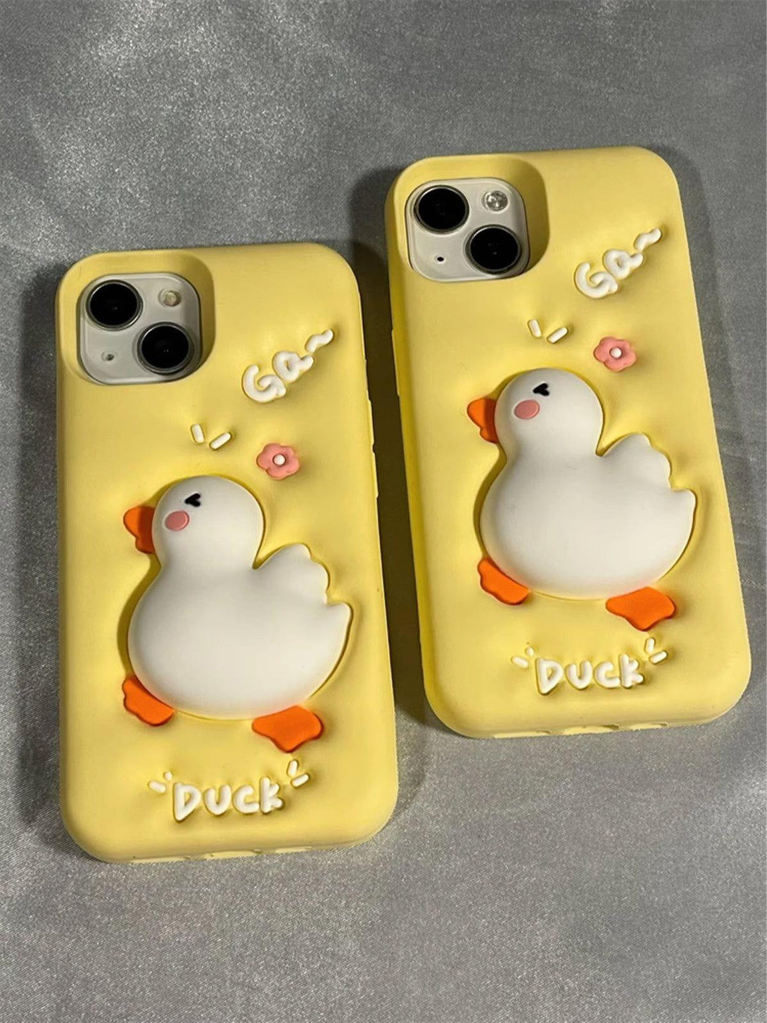 Charming TALISHKO phone case with a 3D duck design and pink floral details on a yellow background.
