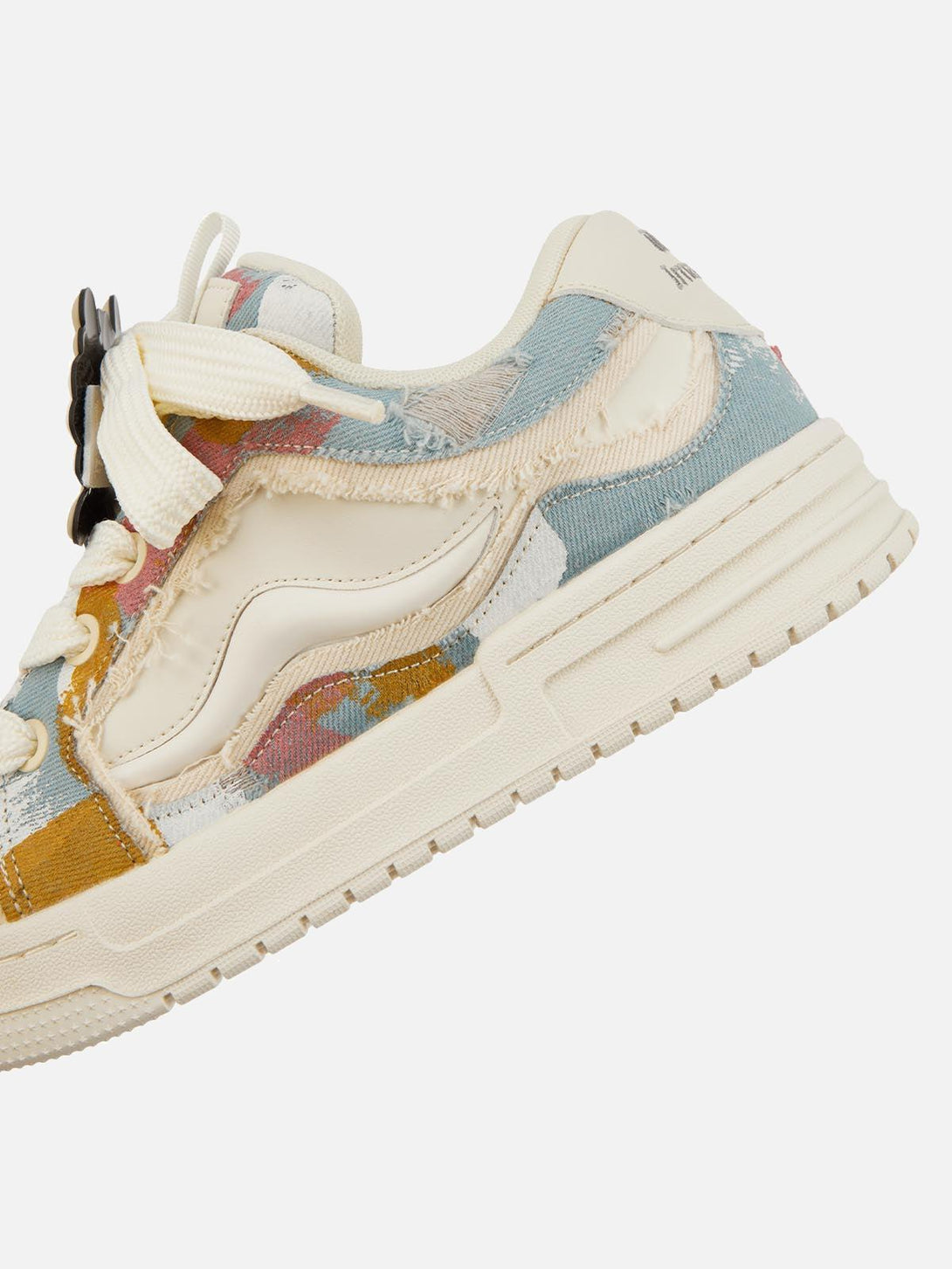 A detailed view of TALISHKO sneakers highlighting colorful abstract patterns and textured fabric.