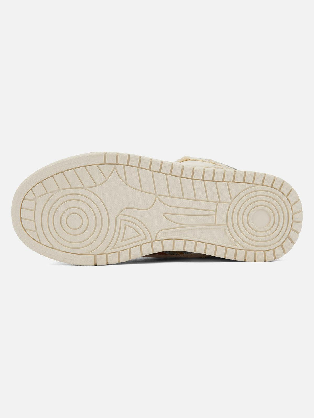 Sole pattern of TALISHKO tassel sneakers, highlighting the unique traction design.