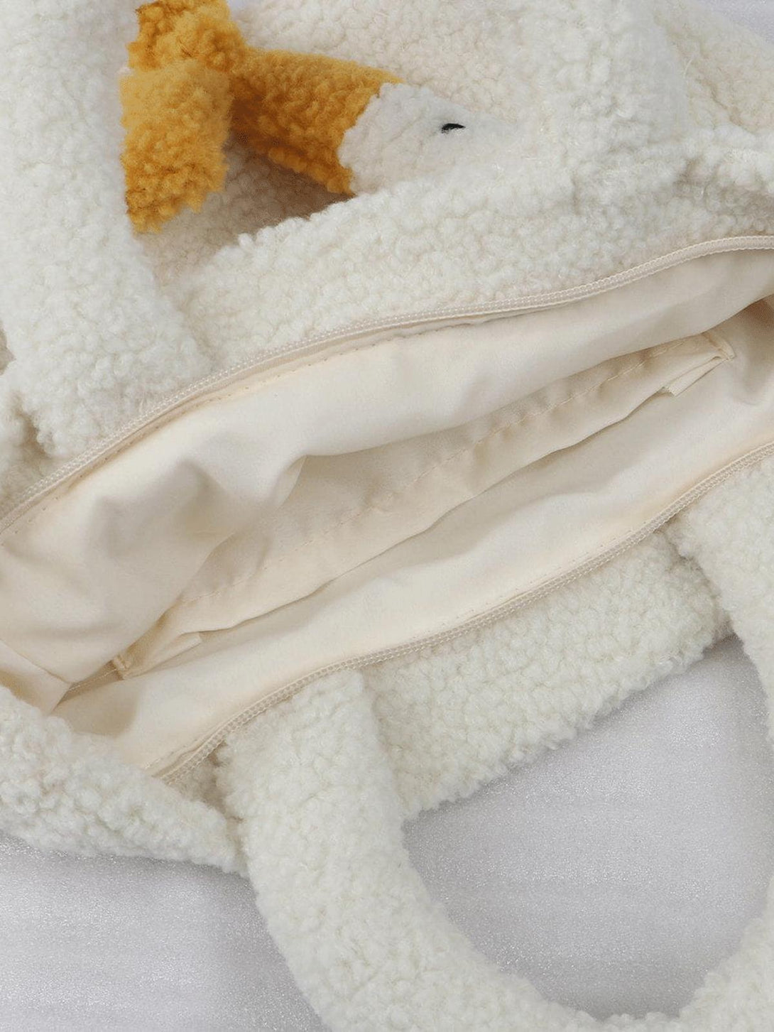A detailed view of the soft sherpa texture on the TALISHKO goose bag, highlighting its cozy design.