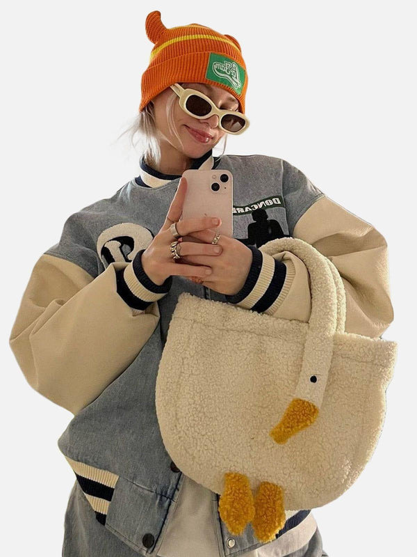 Model showcasing a playful sherpa bag with a goose design by TALISHKO, adding quirky flair.