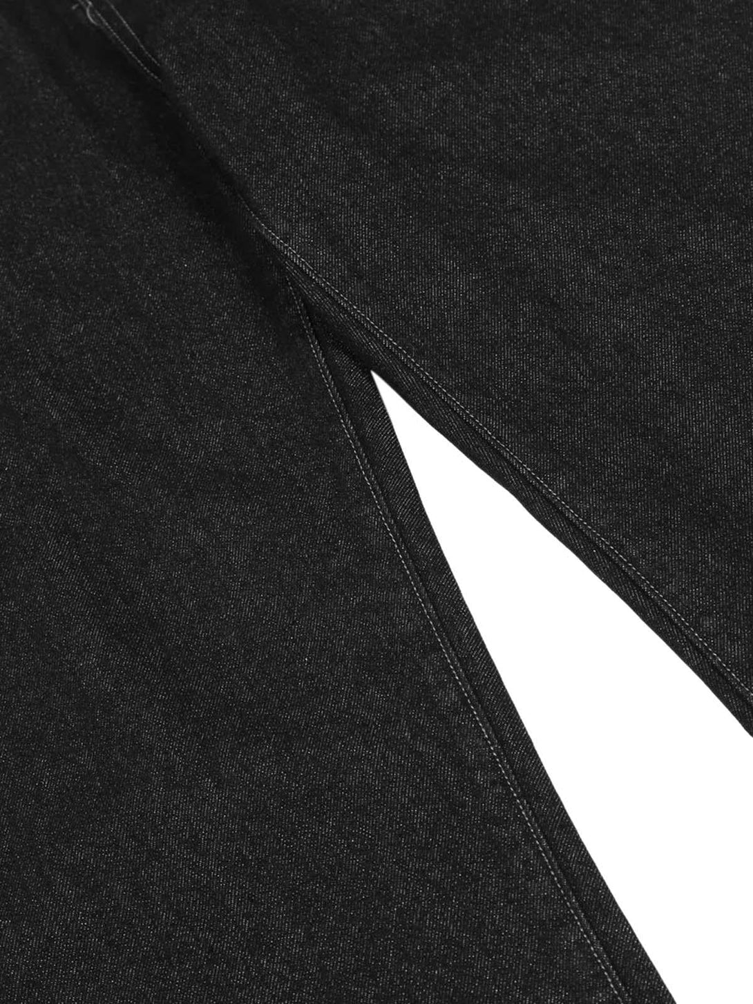 Intricate look at TALISHKO's dark gothic jeans, highlighting the black denim texture and stitching.