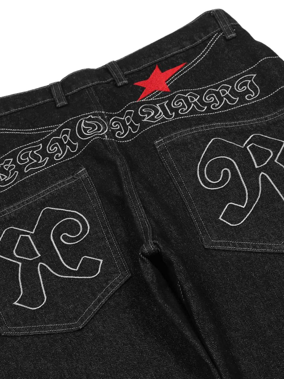Back view showcasing TALISHKO's gothic jeans with bold embroidery and a striking red star.