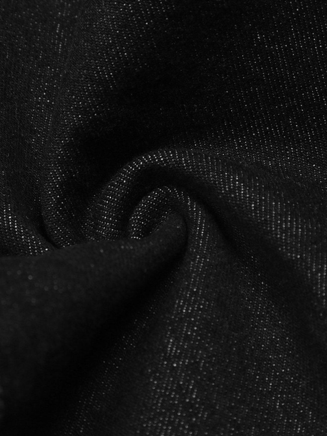 Zoomed-in texture of TALISHKO's dark gothic jeans, showcasing fine black denim weave.