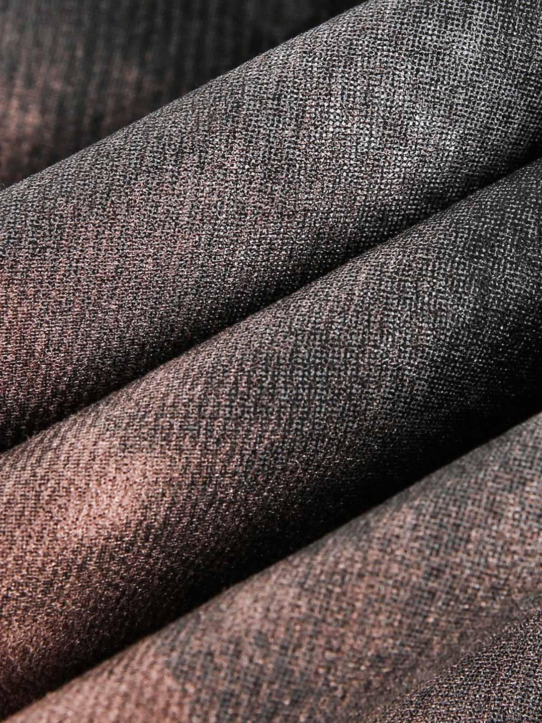 Zoomed-in texture of TALISHKO's dark graffiti suede jacket, showcasing detailed fabric.