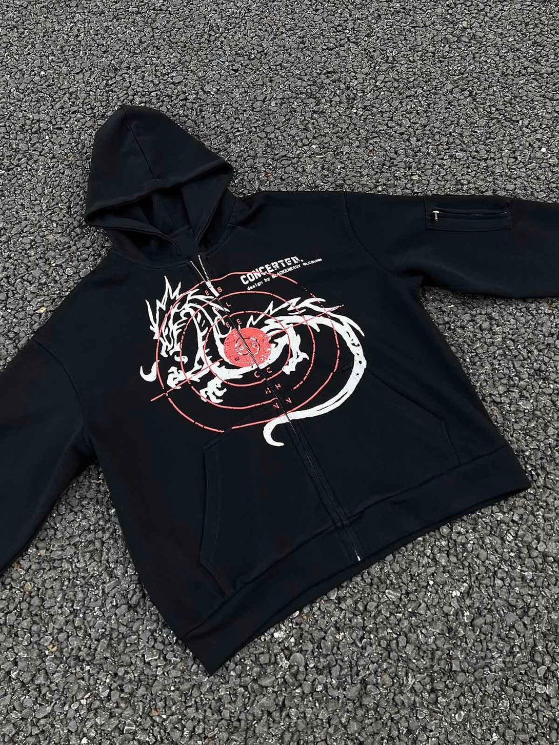 A black hoodie featuring a dragon print by TALISHKO, showcasing its zip-up front design.