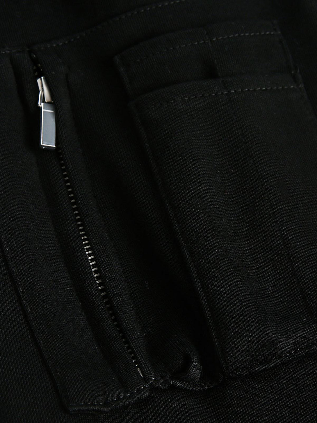 Detailed fabric and stitching on the TALISHKO hoodie, highlighting zipper and pocket design.