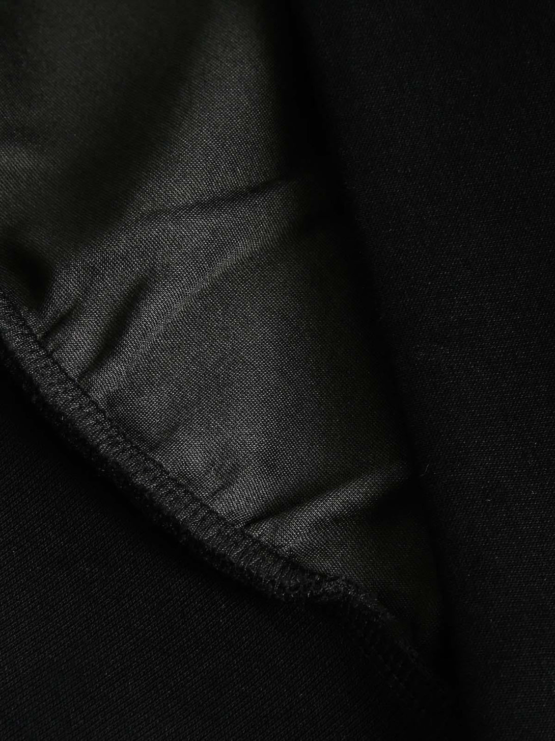 Detailed fabric and stitching on the TALISHKO hoodie, showcasing its sleek interior lining.