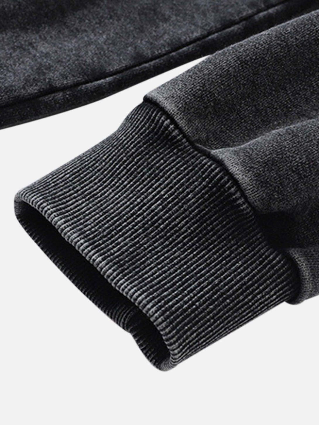 Ribbed cuff detail on a dark TALISHKO hoodie, highlighting its hip-hop style and texture.