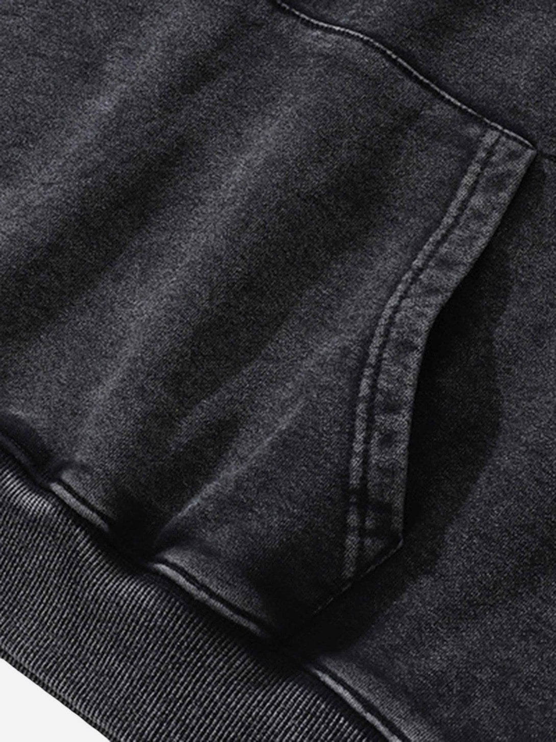 A close-up view of the pocket detailing on a dark TALISHKO hoodie, highlighting its texture.