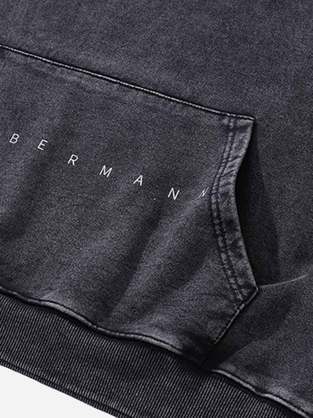 A close-up of the pocket on a dark TALISHKO hoodie, highlighting subtle stitching details.