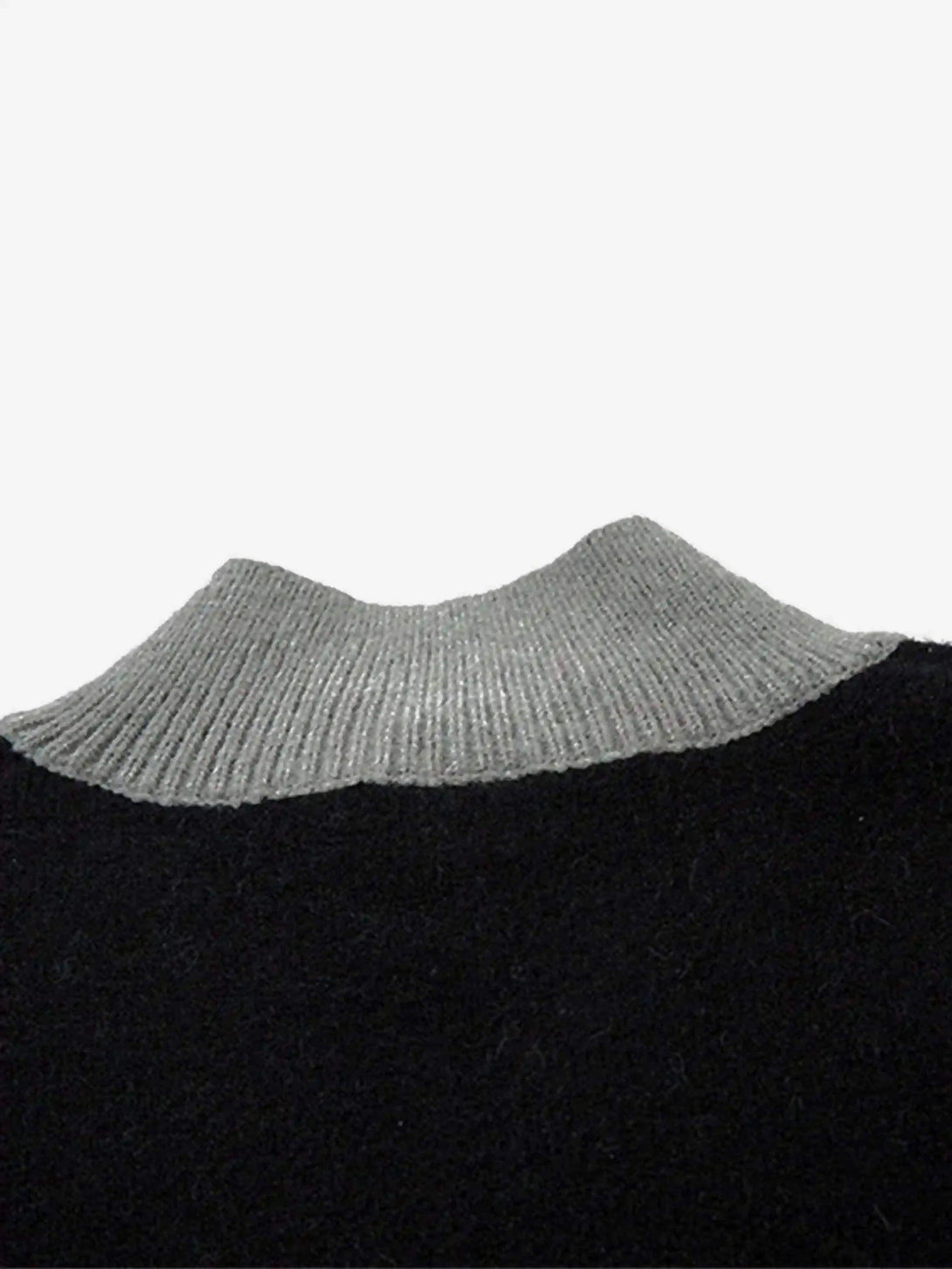 Neck detail of a dark cardigan with a gray ribbed stand collar by TALISHKO.