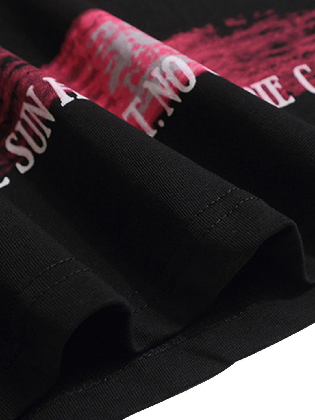 Focusing on the vibrant pink sunset print and lettering on a TALISHKO street rap T-shirt.