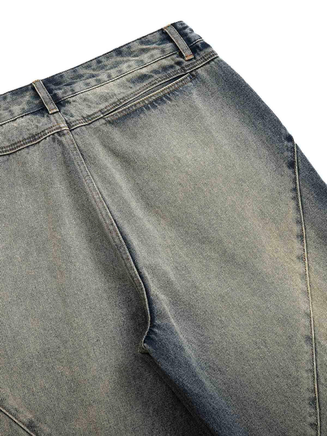 A detailed view of TALISHKO's deconstructed straight jeans, highlighting unique stitching.