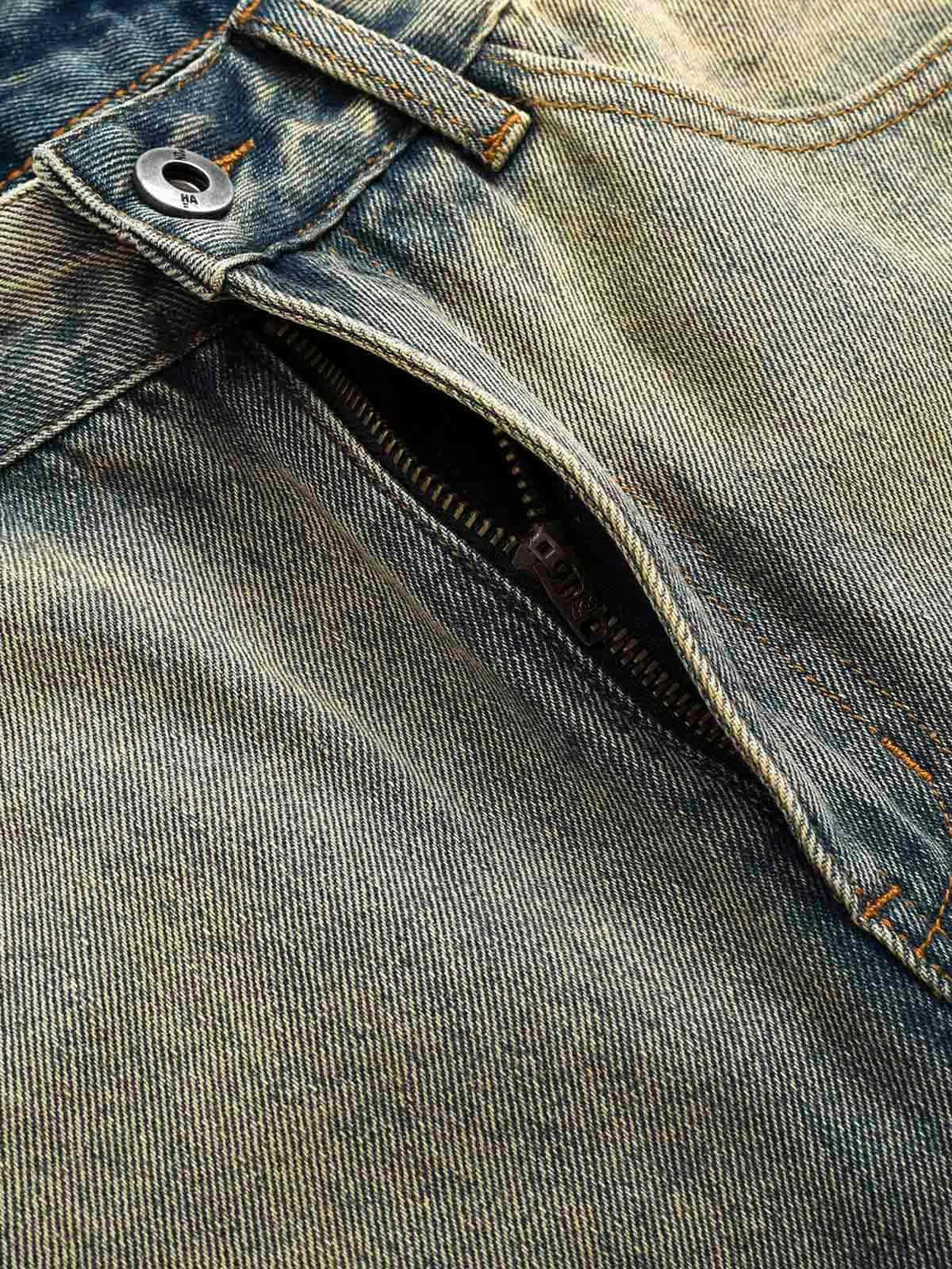 Detailed fabric and stitching of TALISHKO's deconstructed straight jeans with an open zipper.