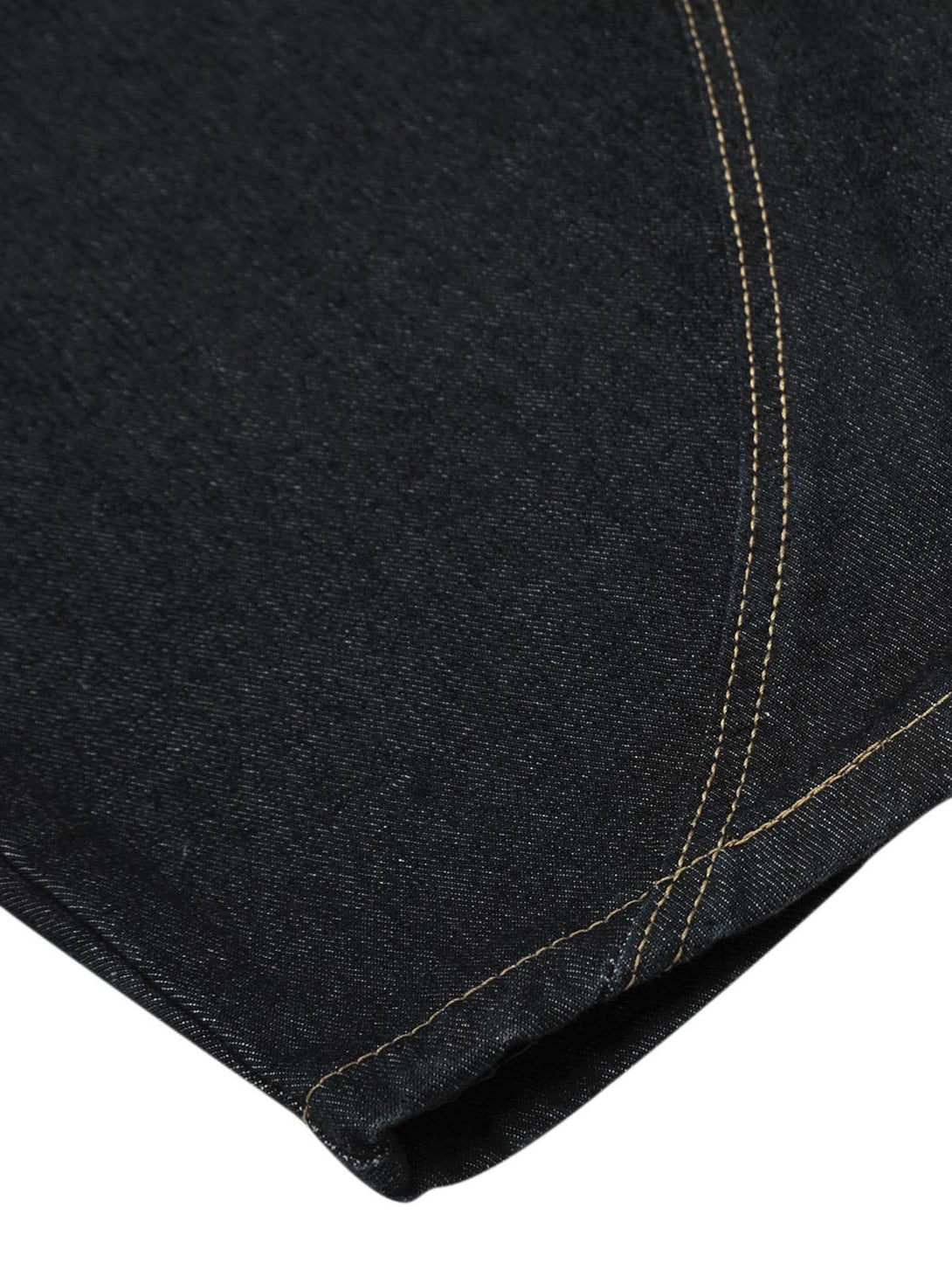 Detailed fabric and stitching on TALISHKO's deconstructed baggy jeans in dark denim.