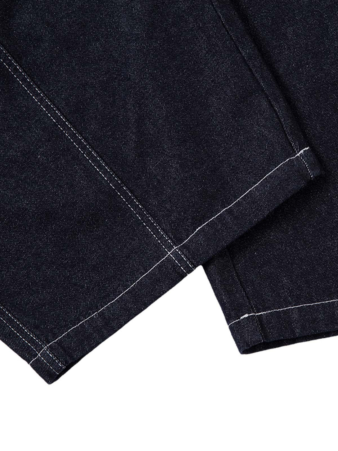 A close-up of TALISHKO barrel jeans, featuring intricate contrast stitching and texture.