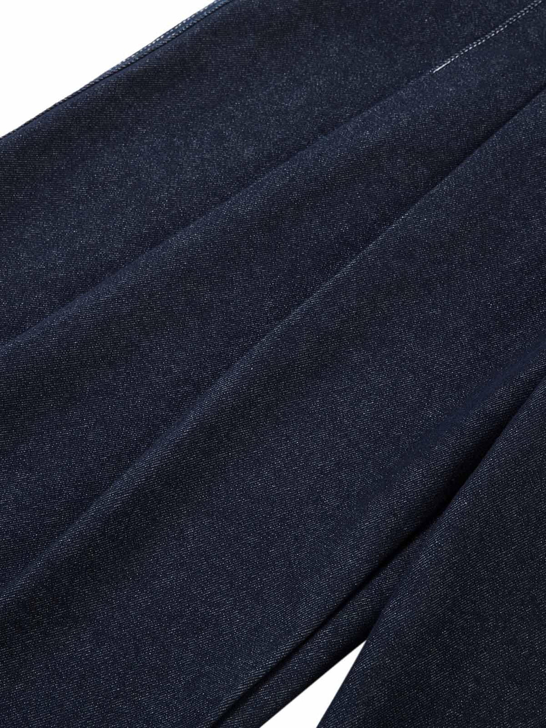 A detailed look at TALISHKO jeans, showcasing the pleated design and rich texture.