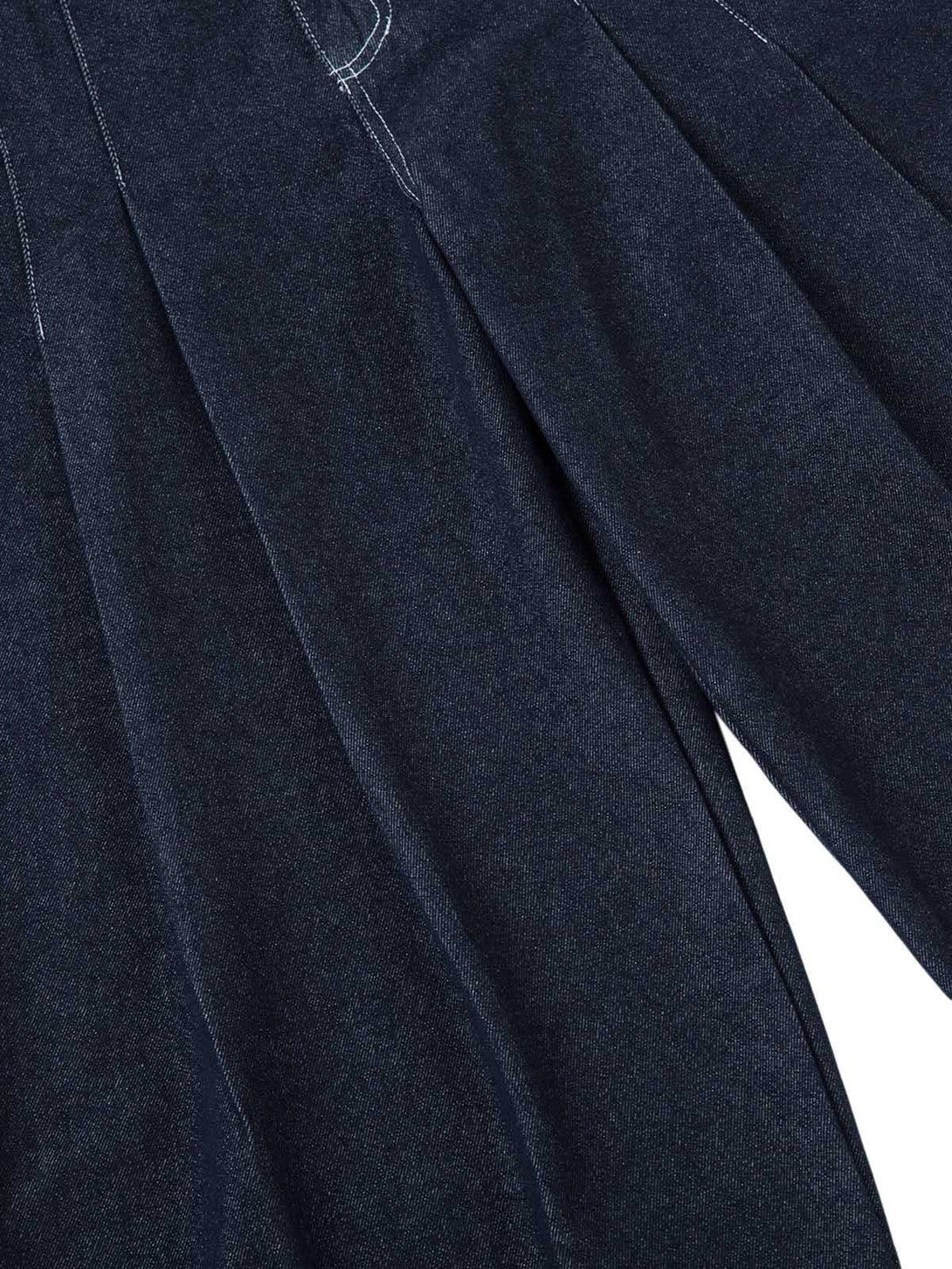TALISHKO jeans featuring a close-up of pleated design and intricate contrast stitching detail.