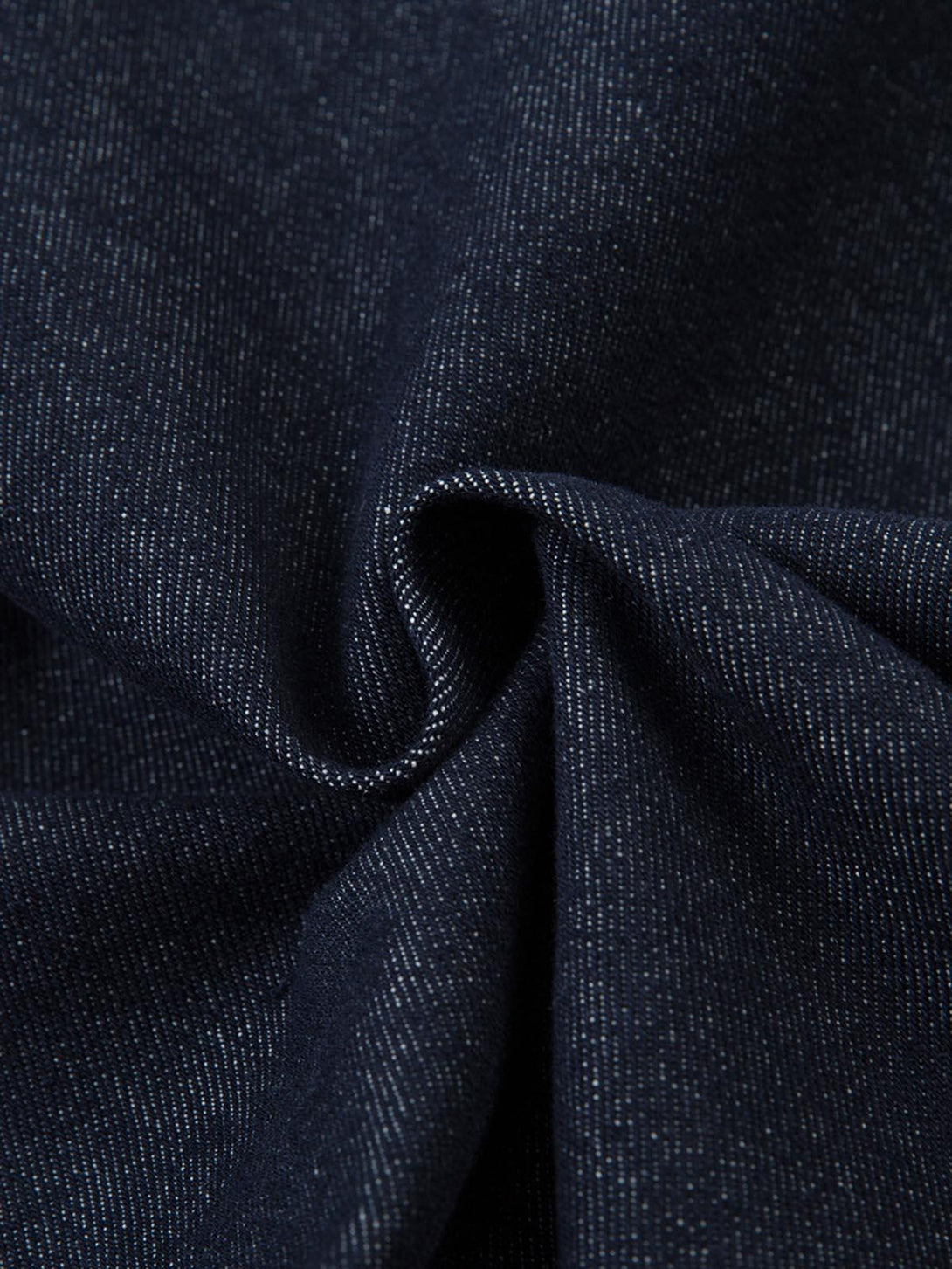 Zoomed-in texture of TALISHKO jeans, highlighting intricate contrast stitching detail.