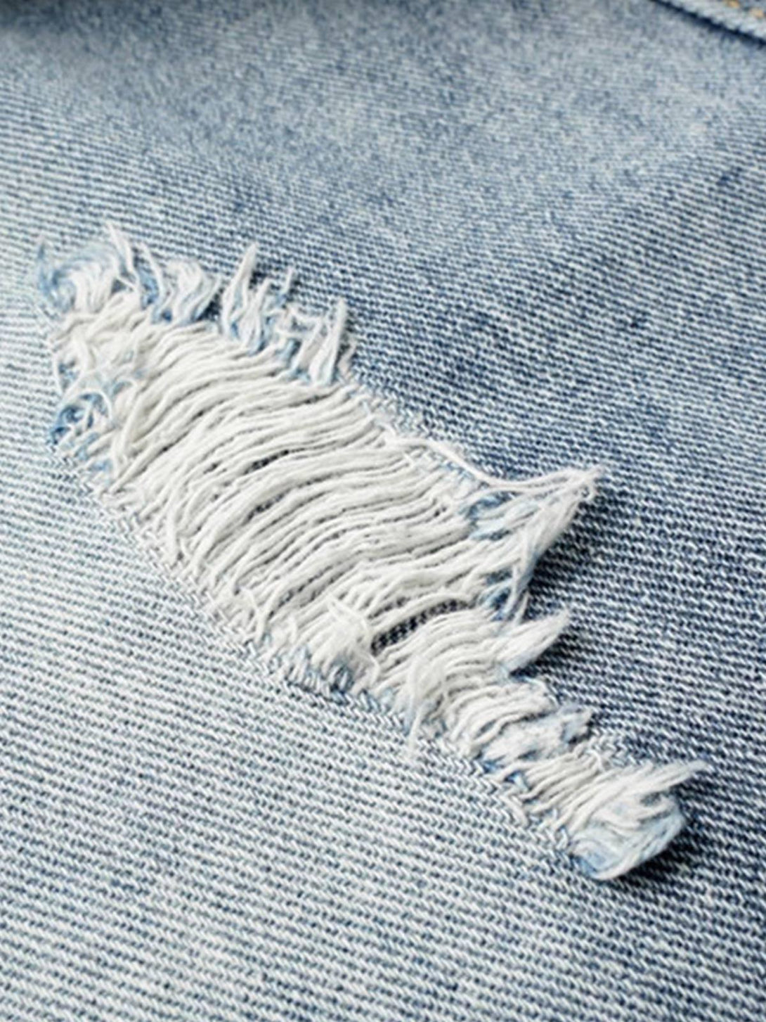 TALISHKO jeans detail showing frayed texture and deconstructed design in light blue denim.