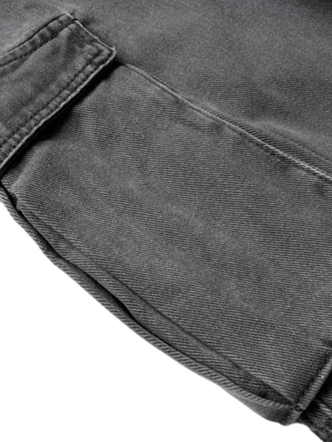 Intricate look at TALISHKO's gray cargo jeans, focusing on the deconstructed design details.