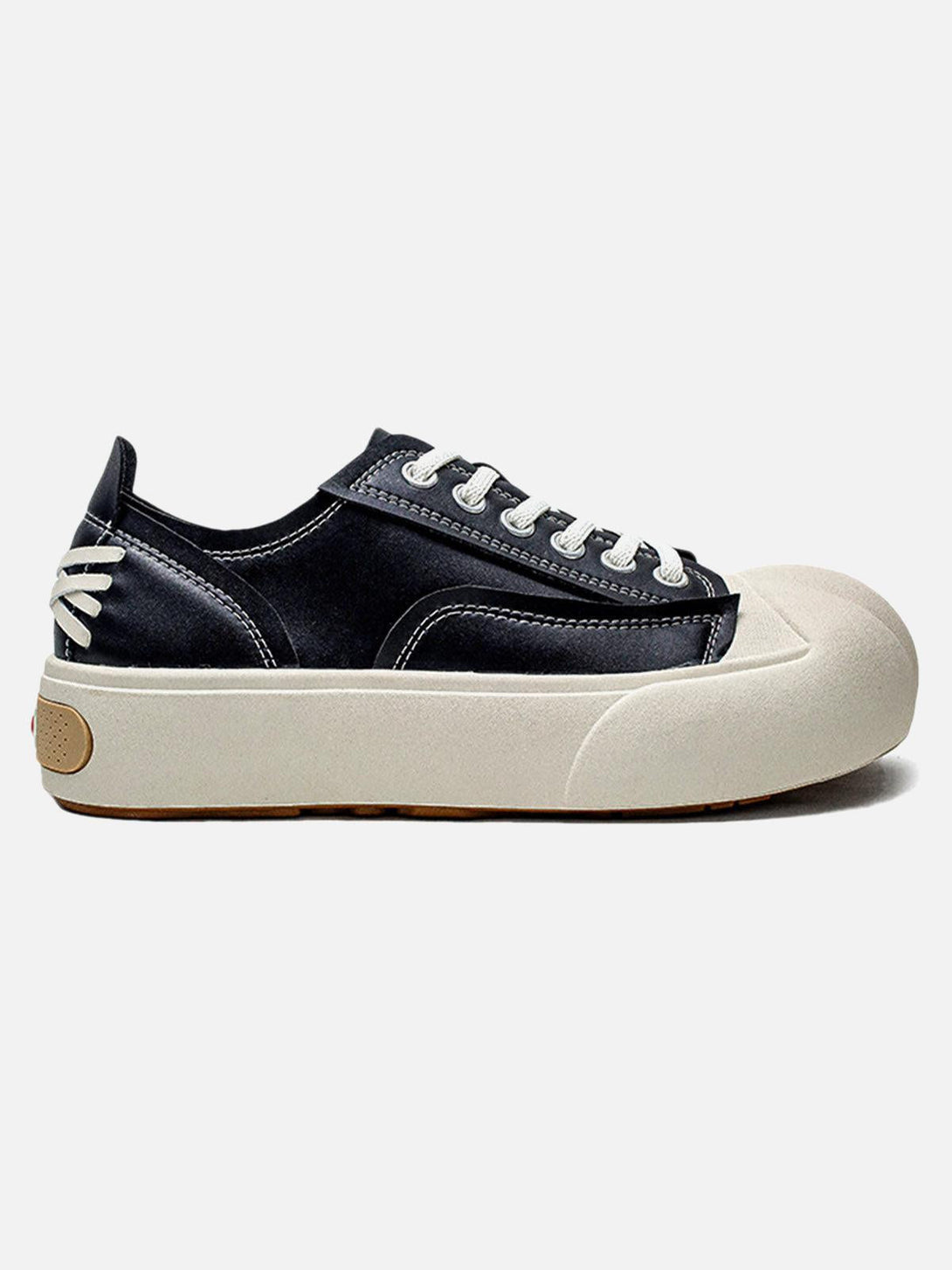 Side view of TALISHKO's deconstructed PU leather casual shoes with unique textured soles.