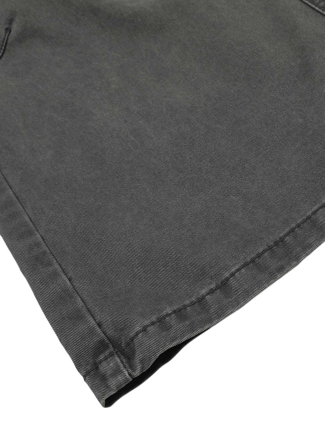 Zoomed-in texture of dark gray cargo pants by TALISHKO, highlighting detailed stitching.