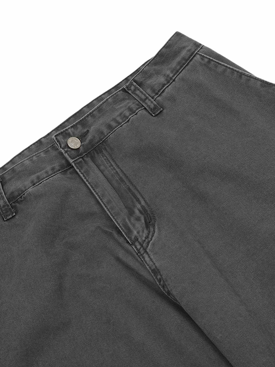 A detailed view of the dark gray deconstructed cargo pants by TALISHKO, showcasing its button and belt loops.