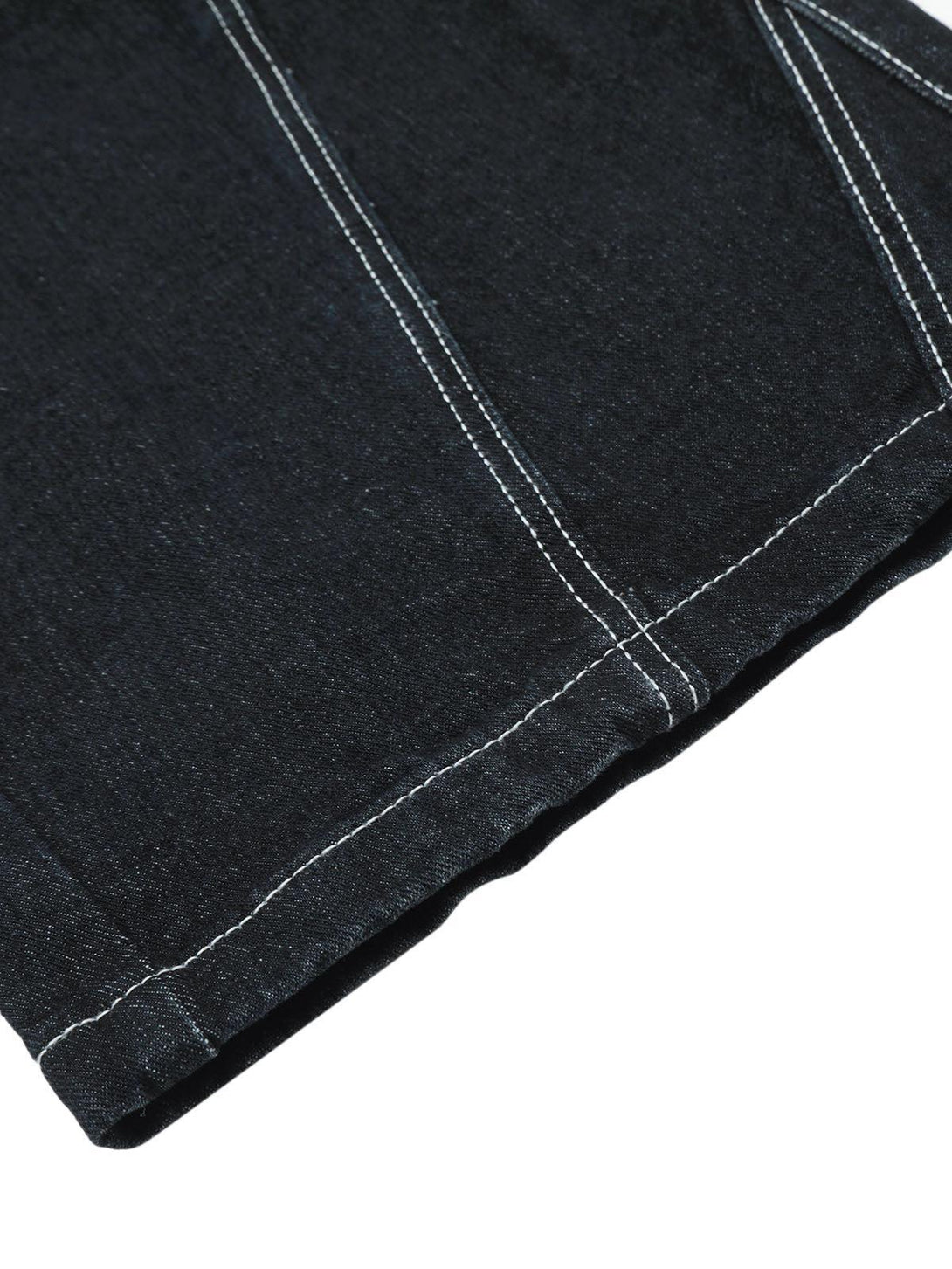 Zoomed-in texture of TALISHKO cargo jeans, highlighting intricate stitching and craftsmanship.