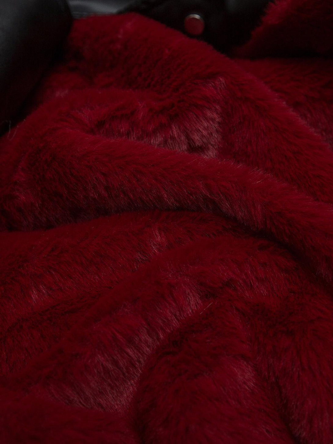Luxurious red fur texture of TALISHKO jacket, showcasing plush and cozy material detail.