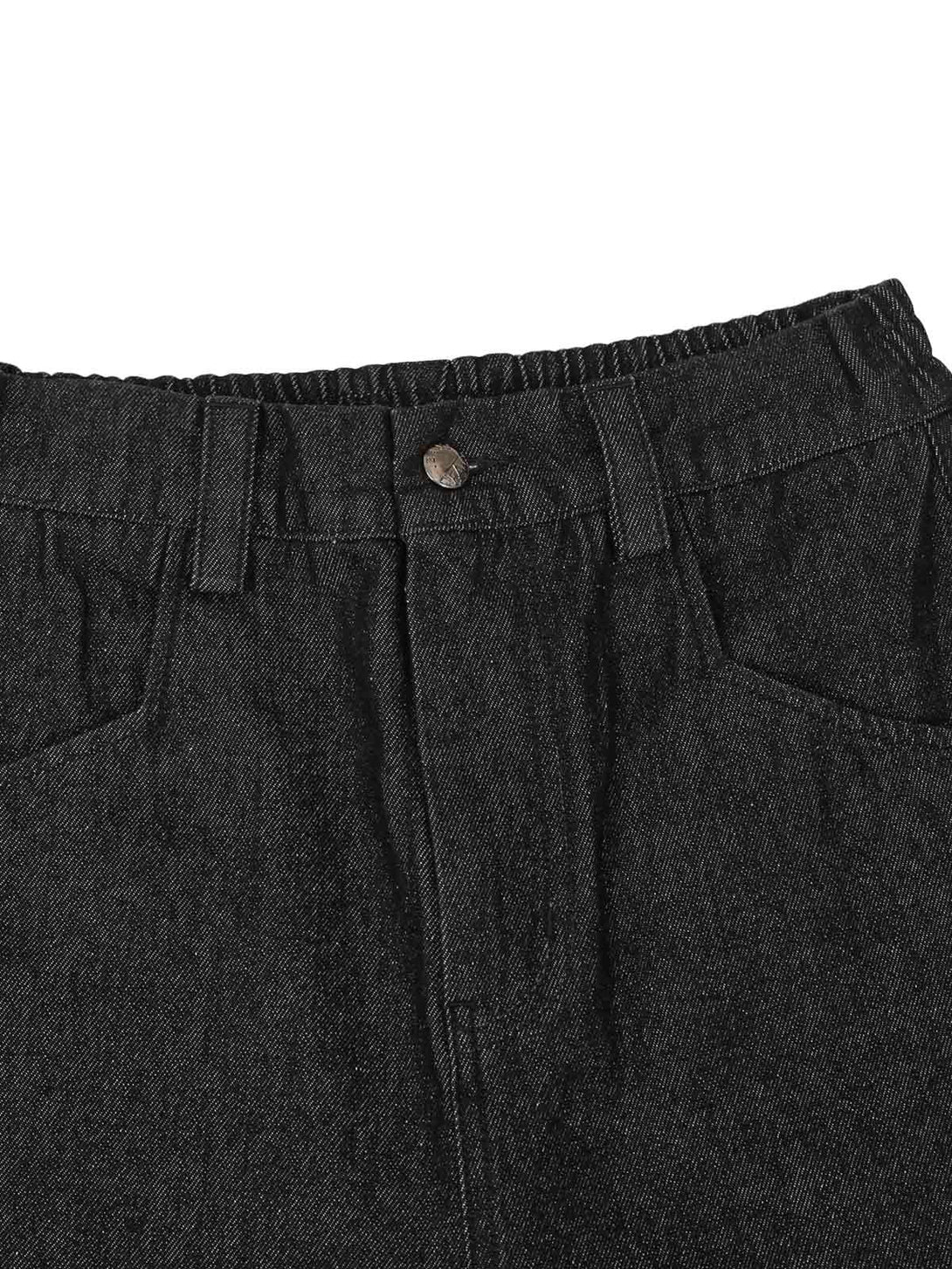 A close-up of TALISHKO's black jeans waistband, highlighting rivet and pocket details.