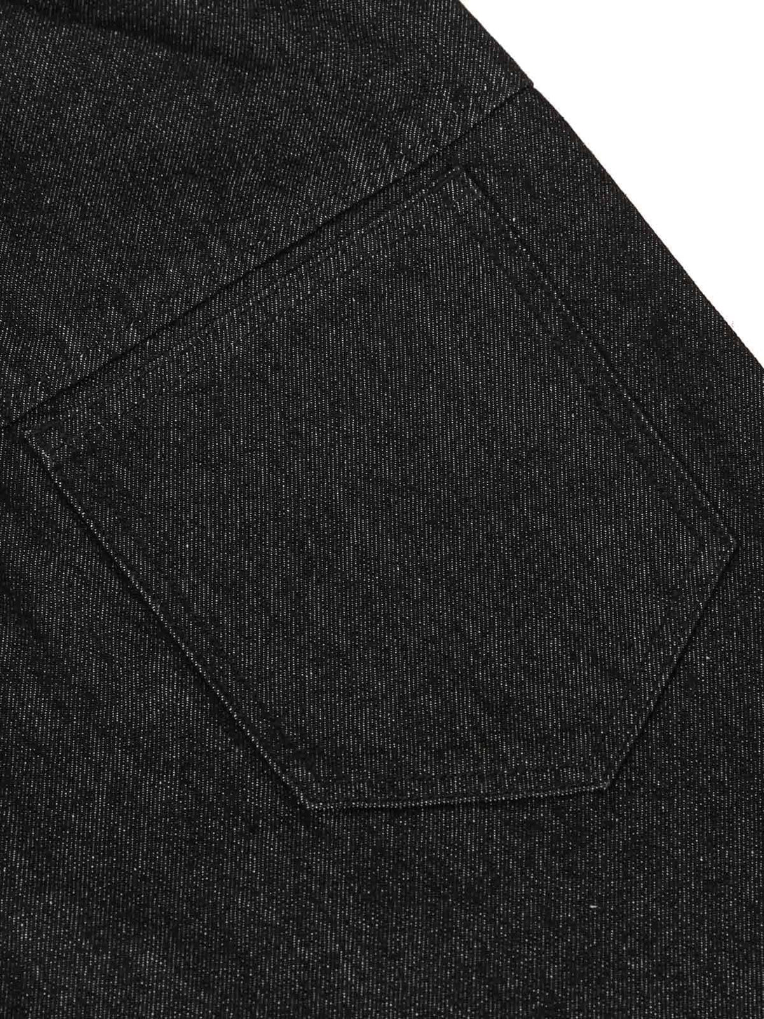 A tight crop highlighting the pocket detail of TALISHKO's deconstructed scimitar jeans.